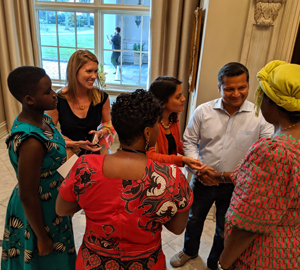 Group of professionally dressed individuals conversing.