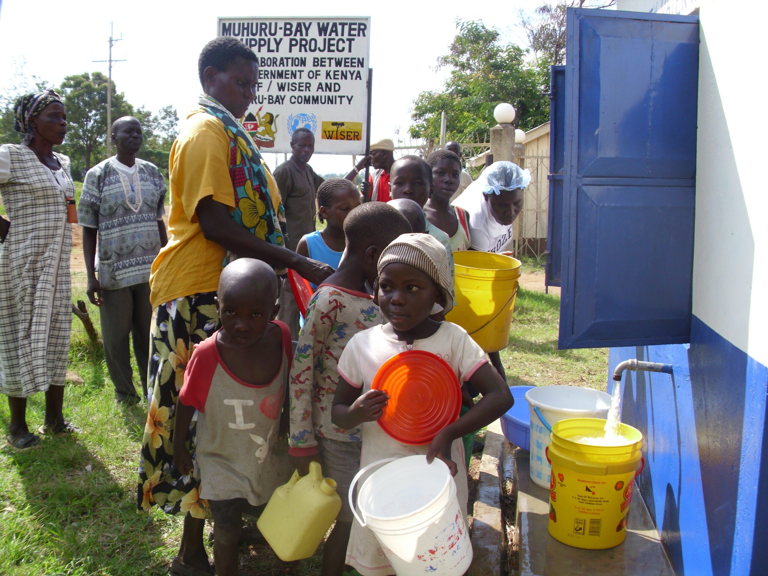 Group of WISER girls lined up and posing for a photo with their hands on their hips, and one girl posing on the ground.