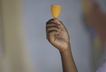 A hand holding a menstrual cup.
