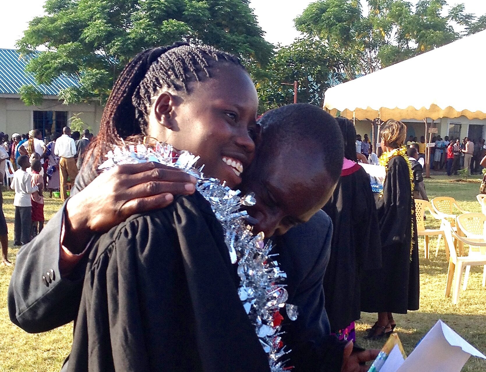 Group of WISER girls lined up and posing for a photo with their hands on their hips, and one girl posing on the ground.